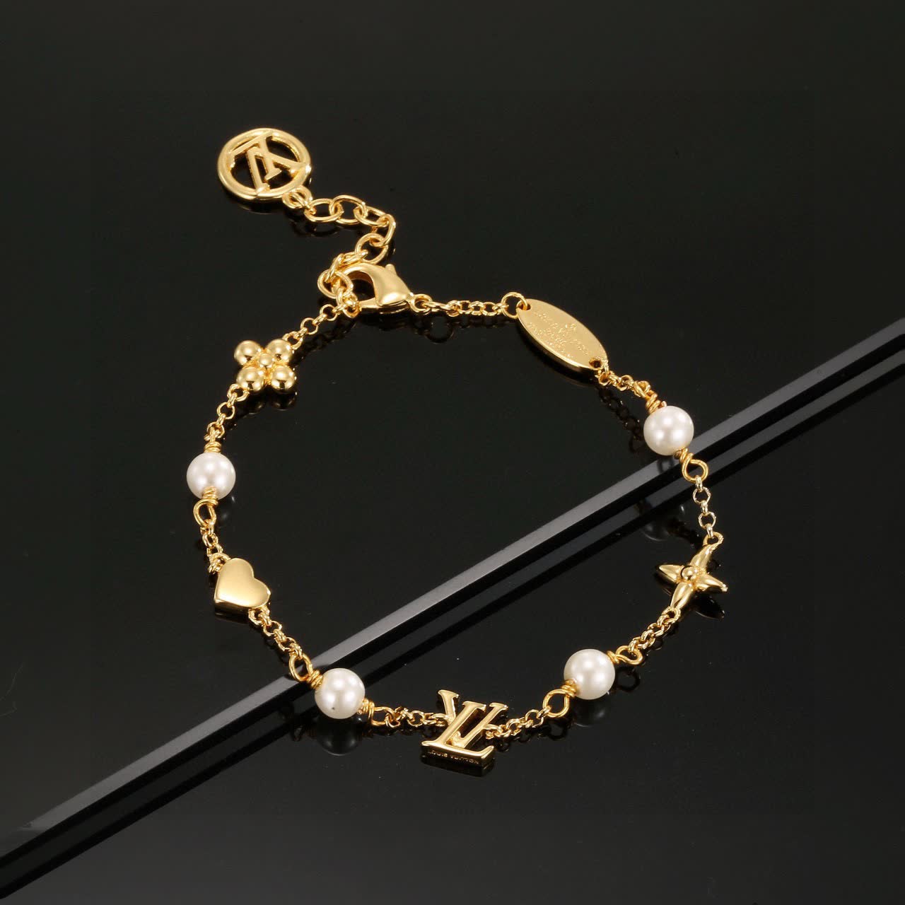 Louis Vuitton Gold Tone Bracelet with Pearls and Charms
